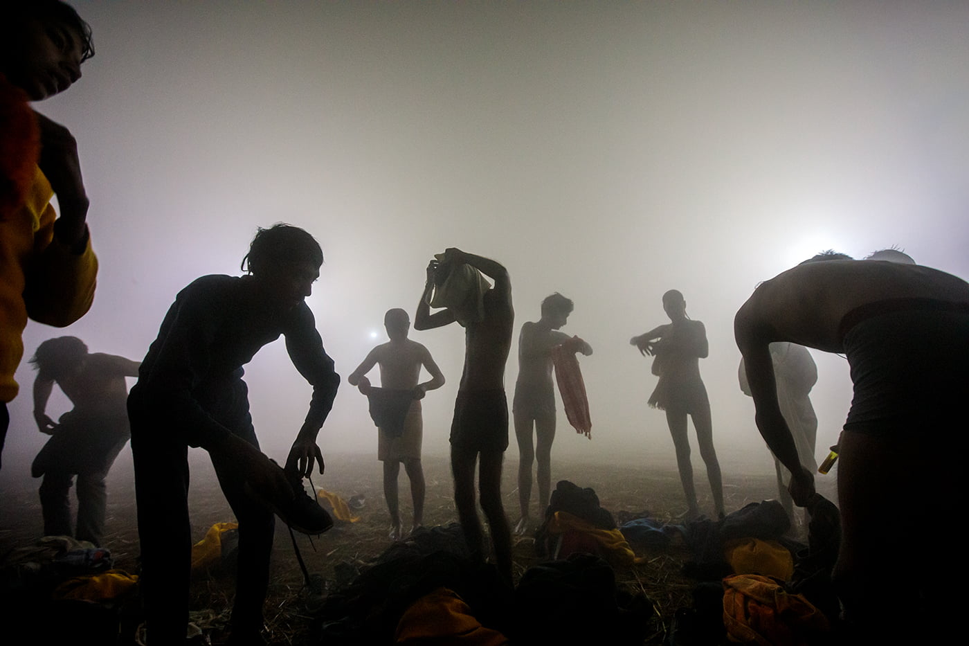 It was an early, foggy morning in the January 2019 Prayagraj Kumbh Mela. I guess the temperature was nearly 10° at that time, and the water was freezing cold. These are the young priests who are really enjoying dipping in the Ganges and playing around.