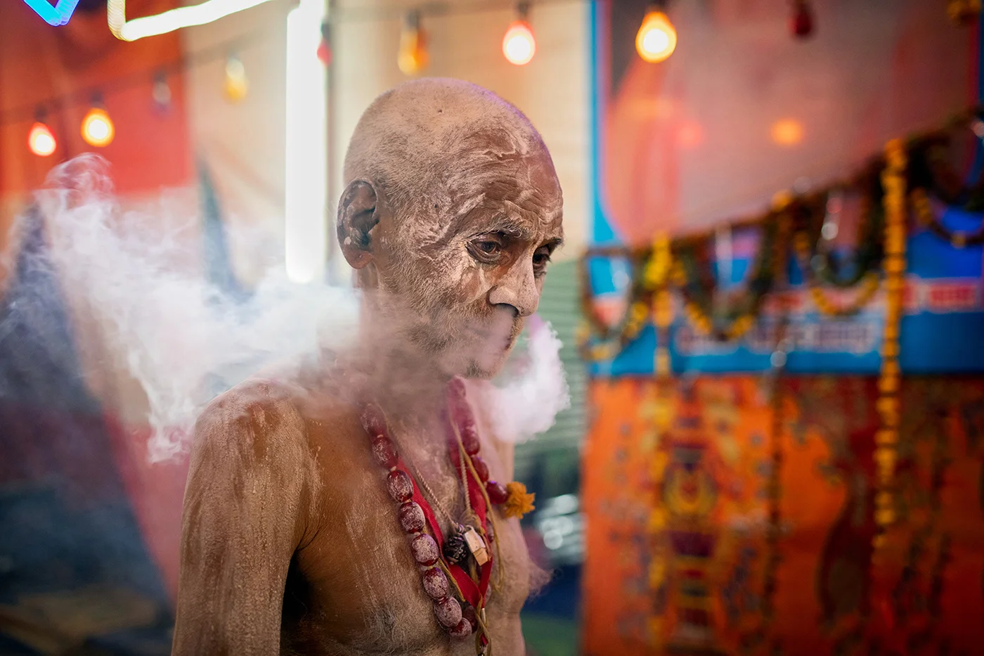 A Naga Sadhu is consuming Charas.