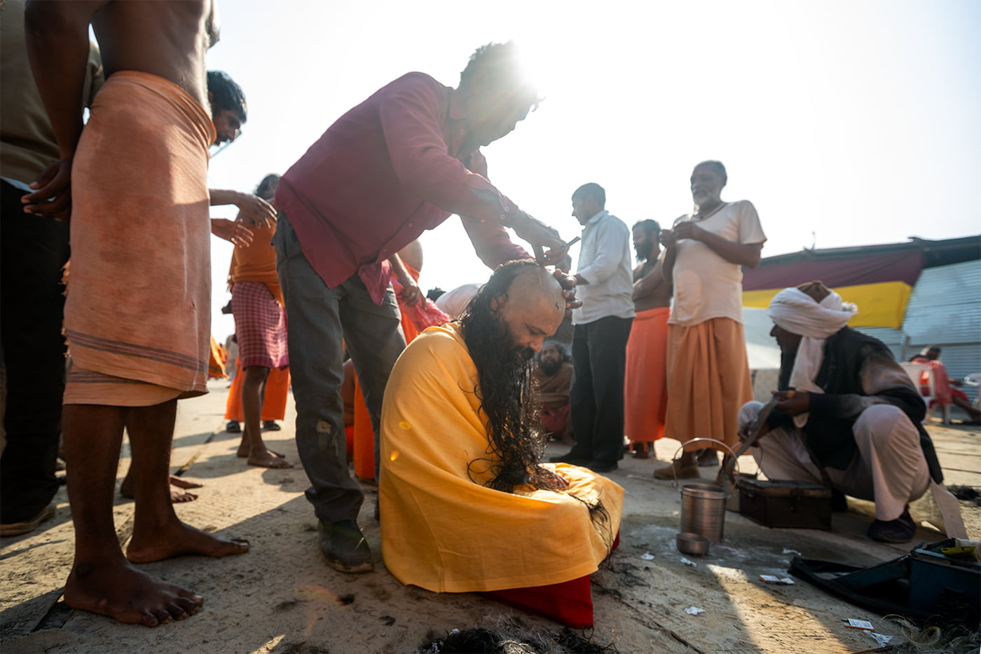 Sadhus are getting a haircut in a ritual before becoming Naga Sadhu.